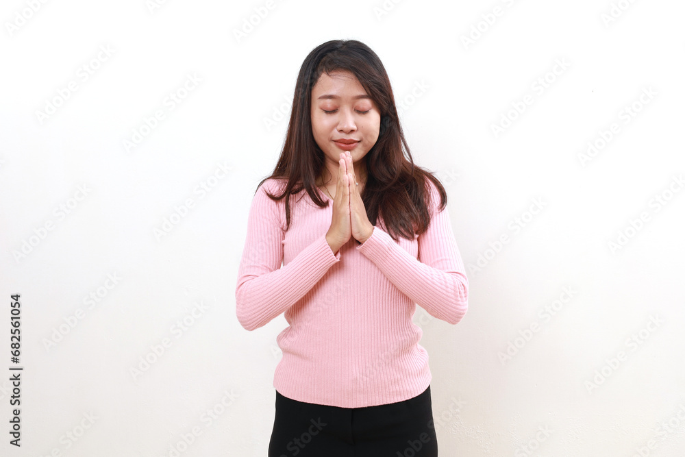 Smiling young asian girl standing with praying gesture. Grateful concept. Isolated on white Smiling young asian girl standing with praying gesture. Grateful concept. Isolated on white