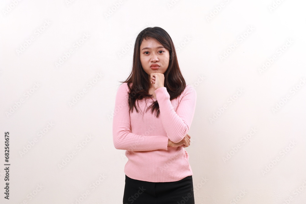 Upset unhappy young asian girl standing while looking at the camera. Isolated on white Upset unhappy young asian girl standing while looking at the camera. Isolated on white