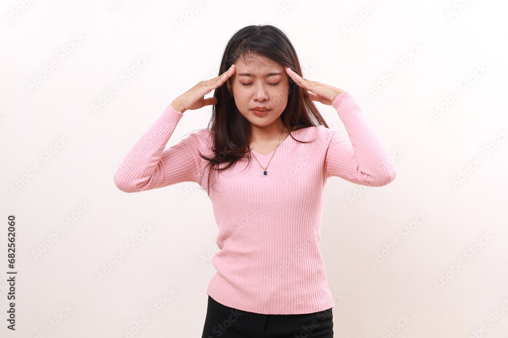 Young asian girl suffering from headache. Hand holds head. Isolated on white background Young asian girl suffering from headache. Hand holds head. Isolated on white background