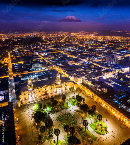 Aerial and night image of the main square of the city of Arequipa, the city and in the background, the Misti volcano, the most important volcano in the Arequipa region. photo