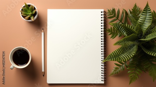 Blank notebook with pencil and plants on desk.