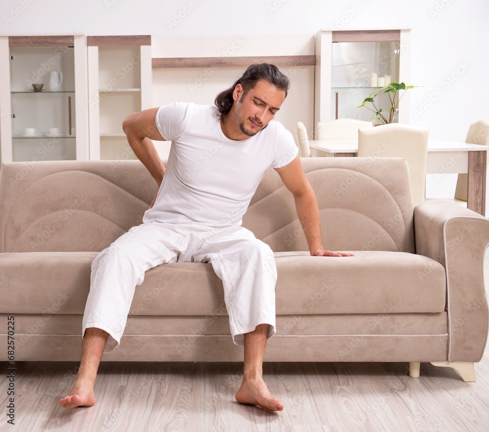 Young man doing physical exercises at home Young man doing physical exercises at home