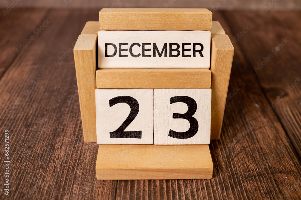 Cube shape calendar for December 23 on wooden surface with empty space for text,cube calendar for december Cube shape calendar for December 23 on wooden surface with empty space for text,cube calendar for december