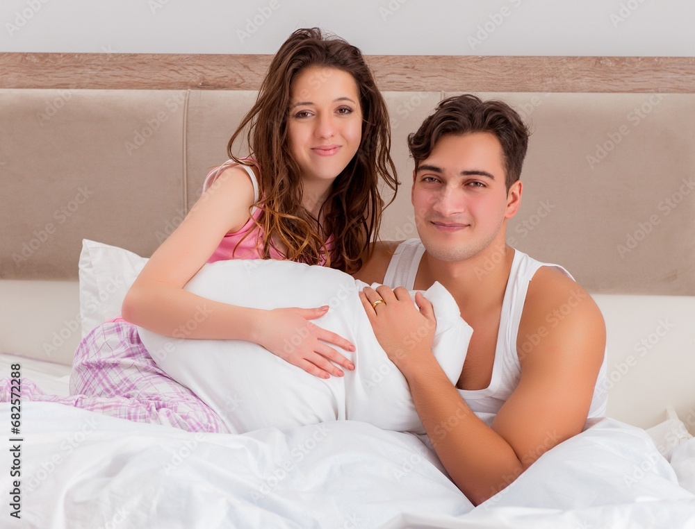 Funny concept with wife and husband in bed Funny concept with wife and husband in bed