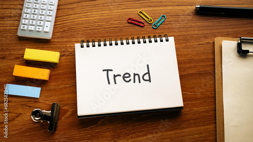 There is notebook with the word Trend. It is as an eye-catching image.
