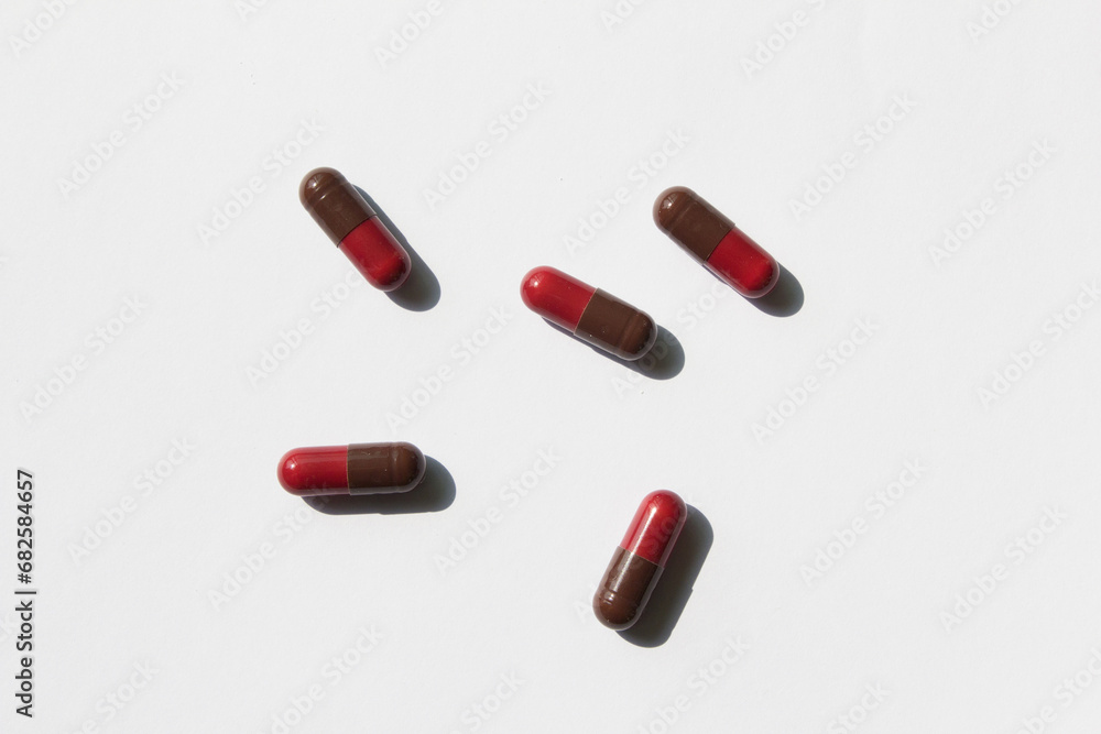red and brred and brown color pills on a white backgroundown color pills on a white background red and brred and brown color pills on a white backgroundown color pills on a white background