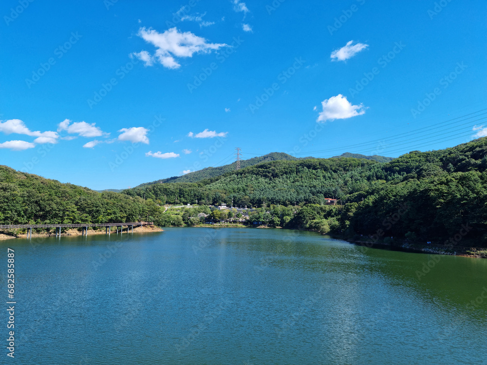 A lake with water sparkling in the sunlight.