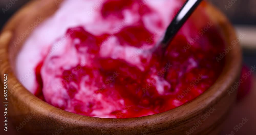 fresh yogurt with crushed juicy raspberries of red color, preparation of yogurt desserts using juice and berries of ripe raspberries fresh yogurt with crushed juicy raspberries of red color, preparation of yogurt desserts using juice and berries of ripe raspberries