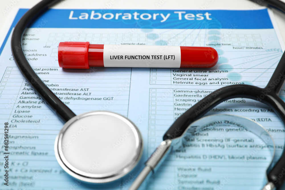 Liver Function Test. Tube with blood sample, form and stethoscope on