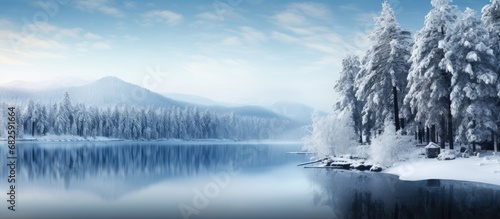 As the winter sky turns a mesmerizing shade of blue, the traveler finds solace in the peacefulness of the snowy landscape, surrounded by towering trees and a sparkling lake reflecting the beautiful