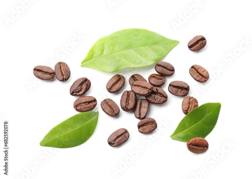 Roasted coffee beans and leaves isolated on white, top view