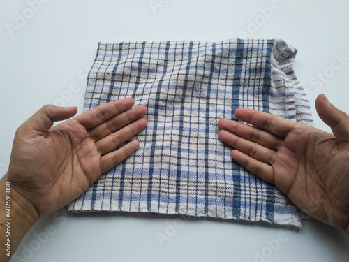 Man's hands cleaning table cloth on white background. Clothes cleaning concept.