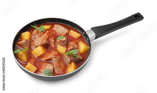 Delicious goulash in saucepan isolated on white