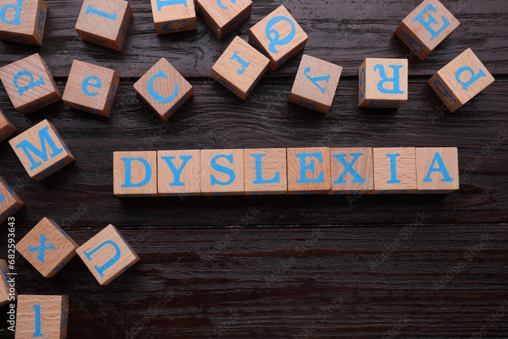 Cubes with word Dyslexia on wooden background, flat lay - obrazy, fototapety, plakaty 