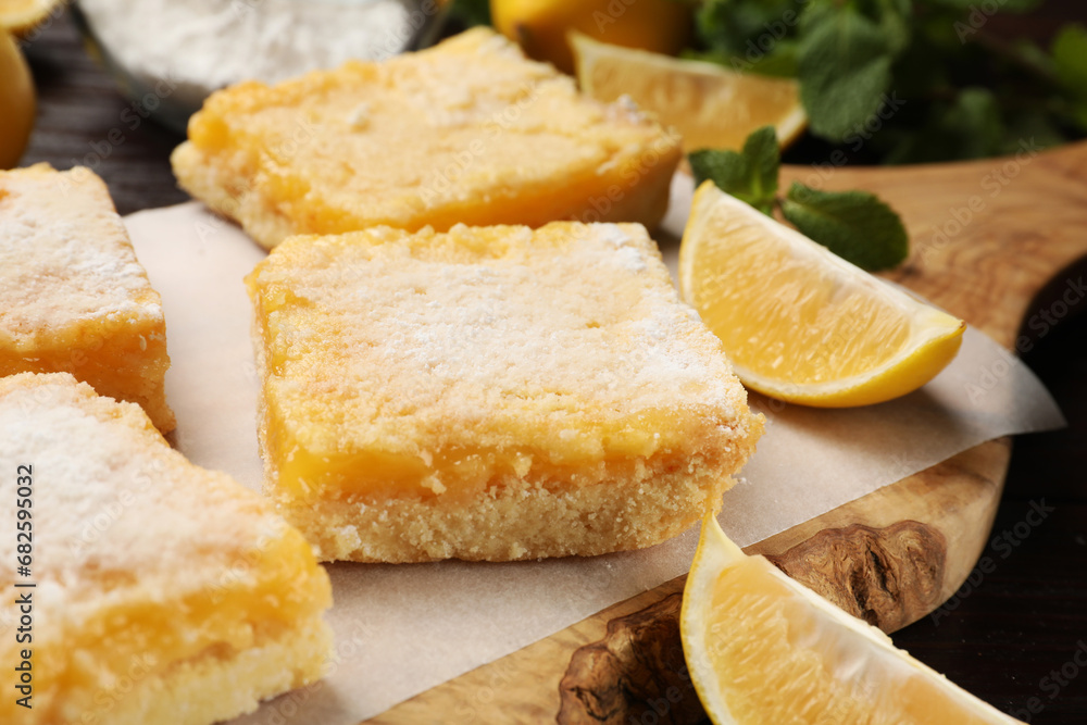 Tasty lemon bars with powdered sugar on table, closeup Tasty lemon bars with powdered sugar on table, closeup