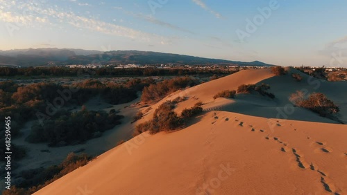 Flying over the golden dunes of Maspalomas during sunset. Gran Canaria. photo