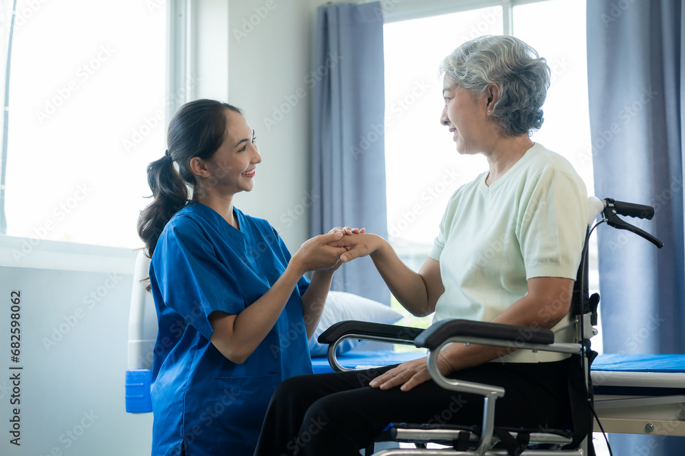 A young Asian nurse at a nursing home takes care of a senior woman. The attending physician provides physical therapy services for elderly patients to exercise for their health. A young Asian nurse at a nursing home takes care of a senior woman. The attending physician provides physical therapy services for elderly patients to exercise for their health.