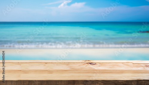 Wood table top on blurred blue sea and white sand beach background - can be used for display or montage your products