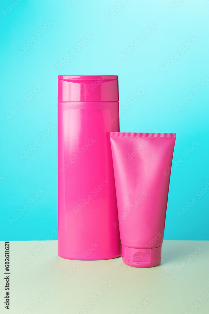 Two tubes of crimson color on a beige turquoise background. Two tubes of crimson color on a beige turquoise background.