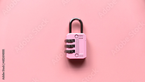 Safety and protection concept. Pink padlock isolated on a pink background photo