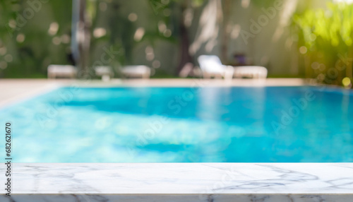 Empty white marble stone table top and blurred swimming pool in tropical resort in summer banner background - can used for display or montage your products.