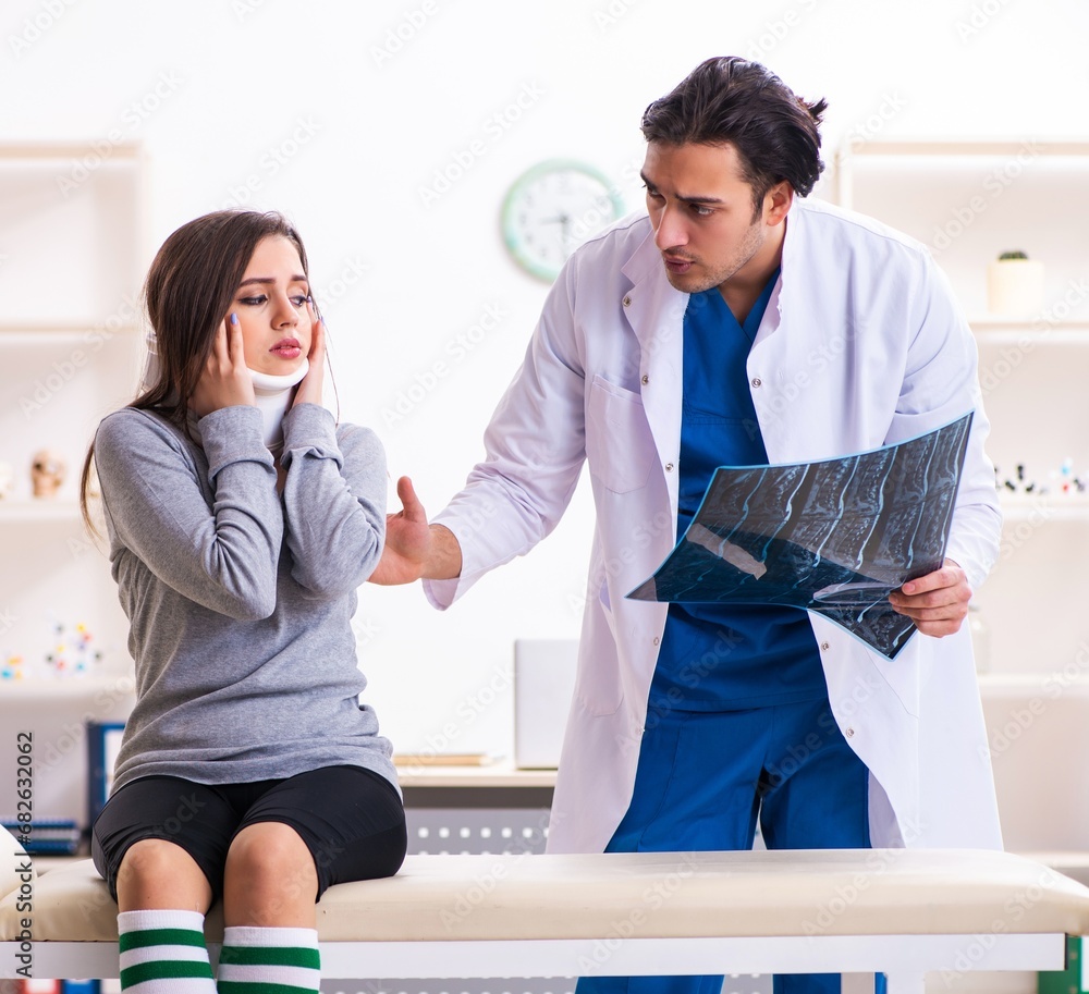 Fototapeta premium Young male doctor and female beautiful patient