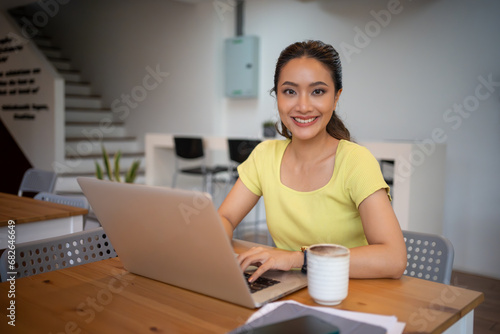 Woman sitting working with laptop at coffee shop  freelance woman working outside Concept.