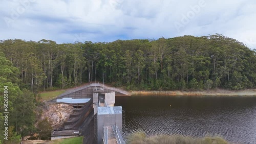 Slow close up aerial over security fences and spillway of Cooloolabin Dam photo