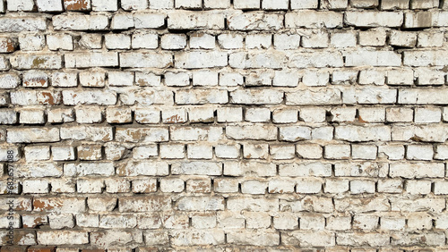 White wall of old dilapidated brick. The background of shabby brickwork.