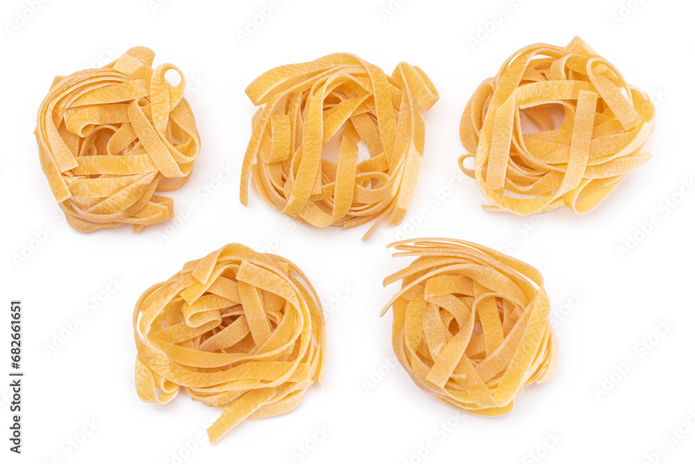 Five Classic Italian Raw Egg Fettuccine - Isolated on White Background. Dry Twisted Uncooked Pasta. Italian Culture and Cuisine. Raw Golden Macaroni Pattern - Isolation Five Classic Italian Raw Egg Fettuccine - Isolated on White Background. Dry Twisted Uncooked Pasta. Italian Culture and Cuisine. Raw Golden Macaroni Pattern - Isolation