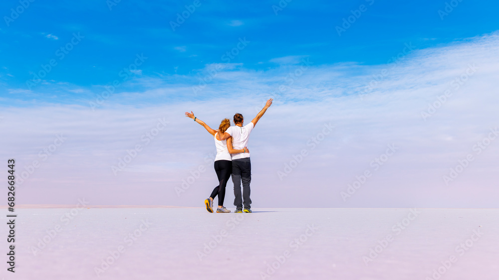 Happy couple on salt flats beach, paradise vacation, serenity, wellness concept(Turkey, Ankara, salt lake, Tuz Gölü ) Happy couple on salt flats beach, paradise vacation, serenity, wellness concept(Turkey, Ankara, salt lake, Tuz Gölü )