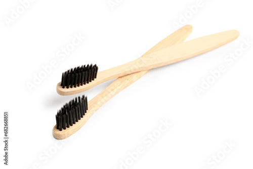 Bamboo toothbrushes on white background