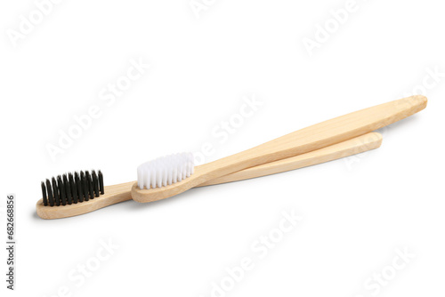 Different bamboo toothbrushes on white background