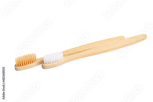 Different bamboo toothbrushes on white background