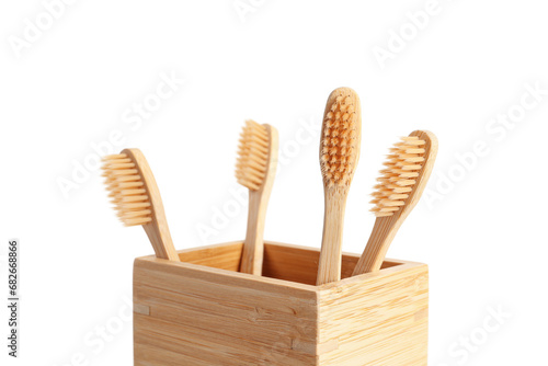 Bamboo tooth brushes in holder on white background, closeup