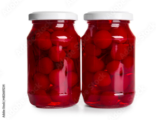 Photos Jars of canned maraschino cherries on white background