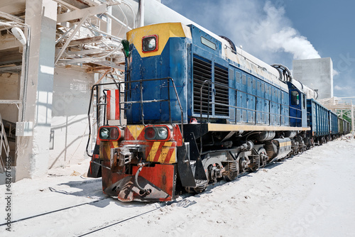 Shunting diesel locomotive moves cars at silica factory