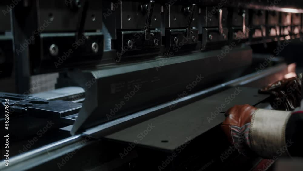 Close up of factory worker molding a steel plate on a hydraulic press. Close up of factory worker molding a steel plate on a hydraulic press.
