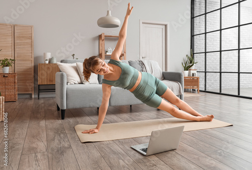 Fototapeta Naklejka Na Ścianę i Meble -  Young woman doing yoga at home