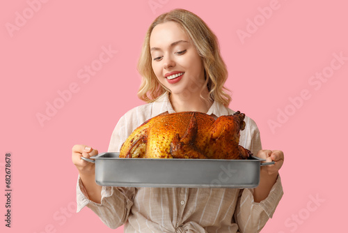 Smiling young woman holding...