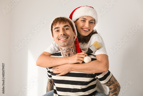 Happy young couple in santa...