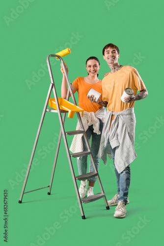 Young couple with paint can...
