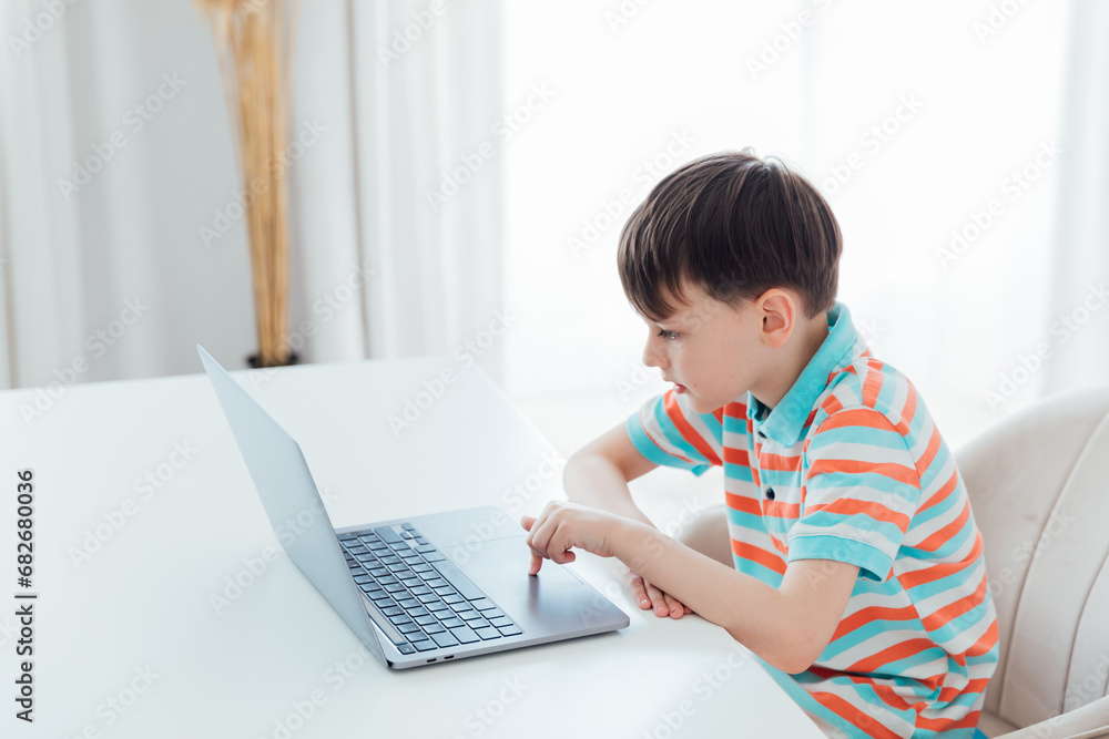 Boy doing learning task at school on computer Boy doing learning task at school on computer
