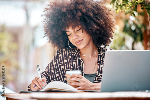 Woman, coffee and smile for writing at cafe in notebook with idea, planning or schedule. Black person, creative or female blogger with laptop for remote work on web for research, article or project