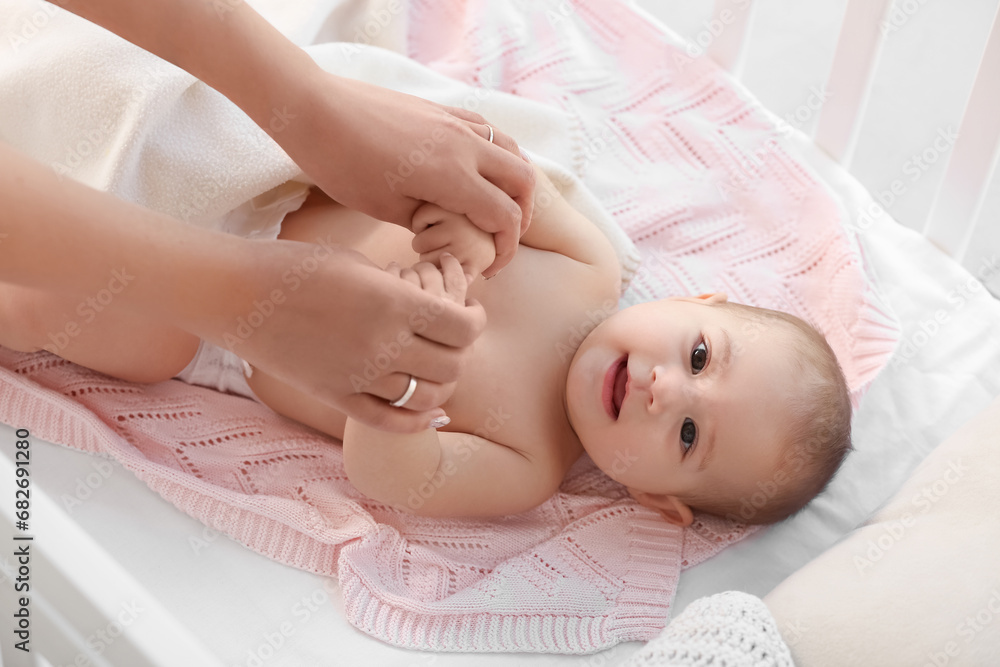 Mother with her little baby in crib, closeup