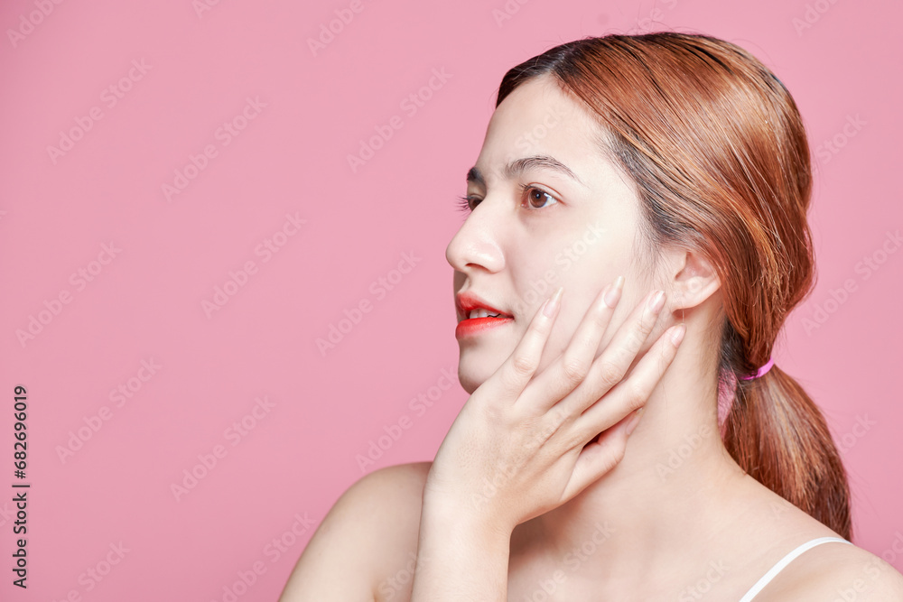Fototapeta premium Beauty asian woman face portrait. beautiful model girl with perfect fresh clean skin color lips red. Facial treatment. Face care, Cosmetology , beauty and spa. Isolated on pink background.