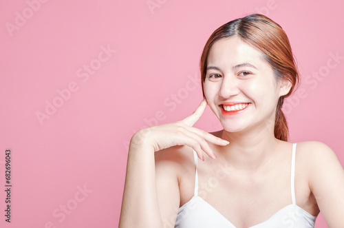Beauty asian woman face portrait. beautiful model girl with perfect fresh clean skin color lips red. Facial treatment. Face care, Cosmetology , beauty and spa. Isolated on pink background.