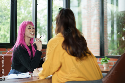 Asian transgender Pink Hair Business People Meeting Design Ideas for new start up project working together meeting business plan listen coworker and discussing team work Gender equality LGBTQ+ concept photo