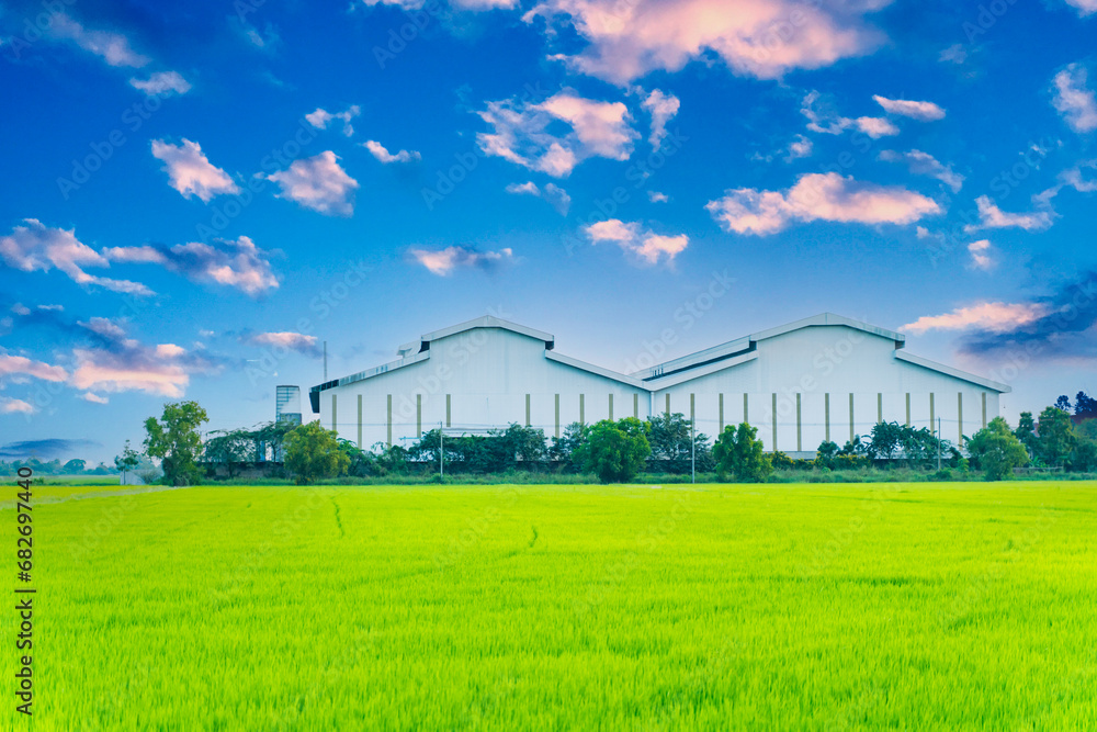 Factory with green fields and bright sky, nature background image