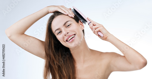 Portrait, happy woman and brush for hair in studio for beauty mock up on white background. Female model, laugh and excitement for detangle, treatment and texture with styling tool for scalp health